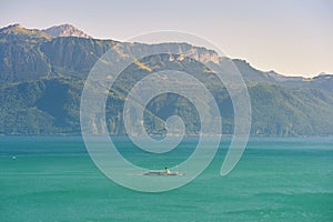 Boat with swiss  flag floating on Lake Geneva or Lac Leman, Switzerland