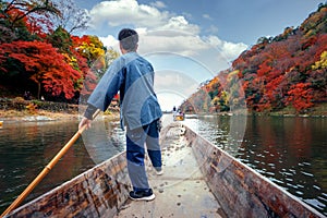 Boat taxi service in arashiyama river with autumn  background