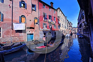 A boat to venice in italy in the canals in town with a gondolier