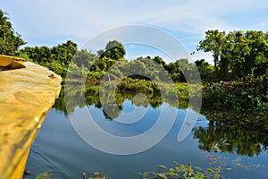 A boat tour in Buxa Tiger Reserve in West Bengal, India. A ride through the jungle. Front of the boat visible to the right.