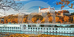 Boat with tourists on Danube river,Bratislava castle and Parliament,Bratislava,Slovakia