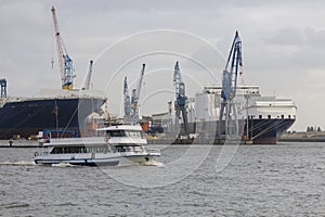 Boat with tourists goes on Elbe river in Hamburg, Germany