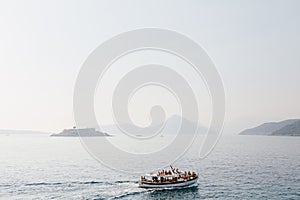 Boat with tourists is sailing to the Mamula island. Montenegro