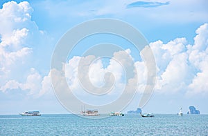Boat tours in the sea  background Island and clouds on the sky  at Krabi in Thailand