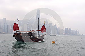 Boat in traditional style in front of Hong Kong island