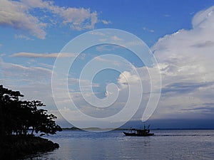 Boat on tranquil Kinabatangan River with reflections , Sabah, Malasia photo