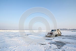 Boat trapped on the Frozen Danube during the 2017 winter, in Zemun, Belgrade, Serbia with ice popping out of the water.