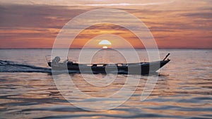 Boat travelling on sunset during night on water