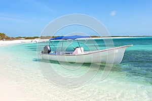 Boat at the tropical beach, archipelago Los Roques photo