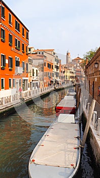 Boat in venice canal with colorful building