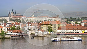 A boat on Vltava River with Prague castle as background