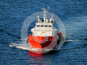 Boat is waiting transfer cargo and crews to platform.