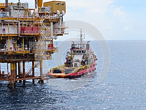 Boat waiting transfer cargo and passenger between oil and gas platform for hard work in offshore.