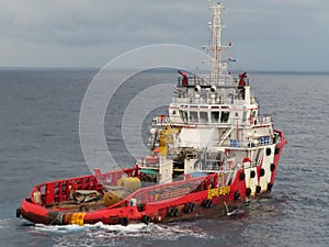 Boat waiting transfer cargo and passenger between oil and gas platform for hard work in offshore.