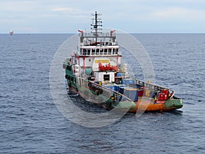 Boat waiting transfer cargo and passenger between oil and gas platform for hard work in offshore.