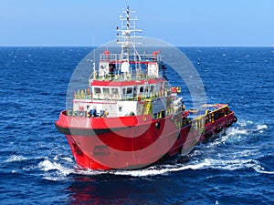 Boat waiting transfer cargo and passenger between oil and gas platform for hard work in offshore.