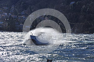 Boat on a windy lake. Splashing waves, lago Maggiore