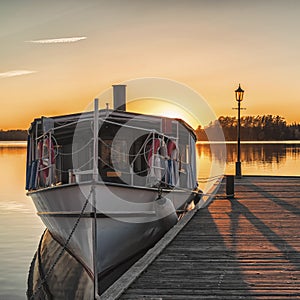 Boat at the wooden pier at sunset time