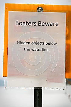 A boaters beware hidden object under water sign