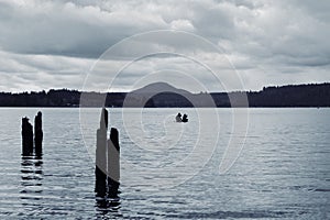 Boaters on Lake Quinault on an overcast, moody day