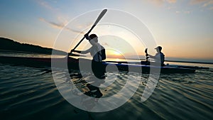 Boaters are ploughing through the sunset waters