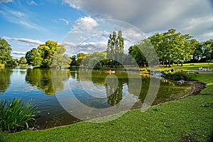 Boaters on small lake at park, Birmingham, England