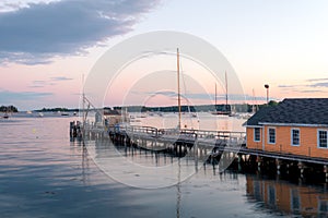 Boathouse and dock in the harbor at dusk