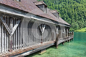 Boathouse German Konigssee with steep mountains and clear transparant water