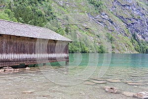 Boathouse German Konigssee with steep mountains and clear transparant water