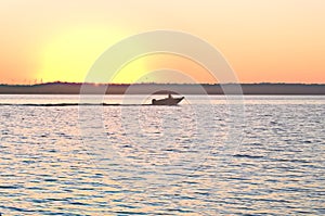 Boating as Sun rise`s at Lake Fort Phantom near Abilene Texas. photo