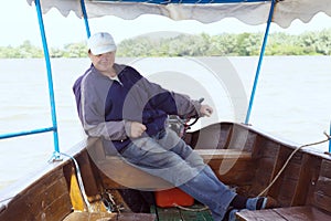 Boatman in a pleasure boat, on the Danube River, Vilkovo, Ukraine