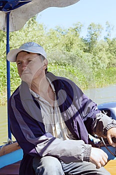 Boatman in a pleasure boat, on the Danube River, Vilkovo, Ukraine