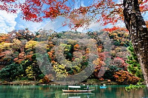 Boatman punting the boat for tourists visit Katsura River