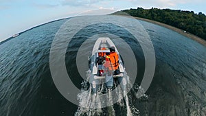 A boatman riding his boat on river.