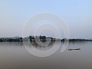 Boatman with a river view on evening sky background