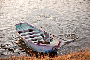 Boatman rowing the boat in Arthur lake