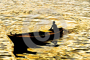 Boatman sailing on his wooden boat