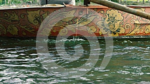 The boatman swims by boat to the shore river.