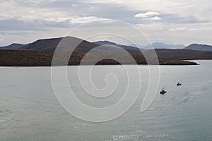 Boats against hills