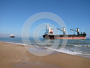 Boats aground at Saler beach, Valencia, Spain. Container ship after running aground. run aground after a gale wind storm