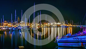 Boats in Alghero harbor at night