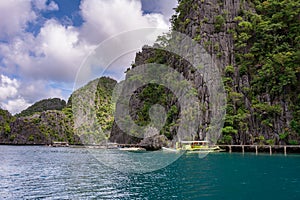 Boats along the rocky coast of the island in the sea, Palawan Philippines