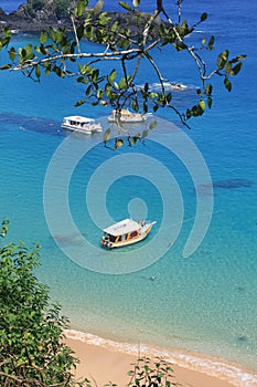 Boats anchored on clear waters