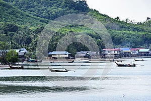 Boats anchored in front of fishing village on Ko Yao Noi island, Phang-Nga Bay, Thailand