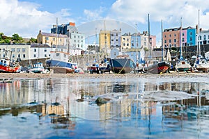 Boats in the bay at low tide with town view in Tenby bay, Wales