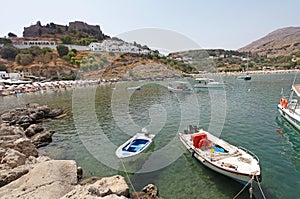 Boats, beach and Actopolis in Lindos Rhodes island, Greece