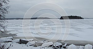 Boats on the beach of icy lake