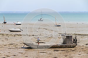 Boats on the beach at low tide in Cancale