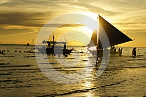 Boats on beach at sunset