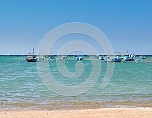 Boats beach waves blue sky